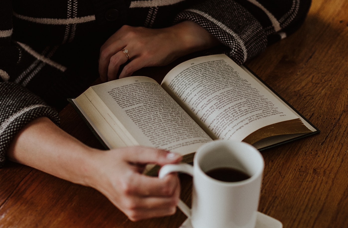 An open book and a cup of coffee, mid-read